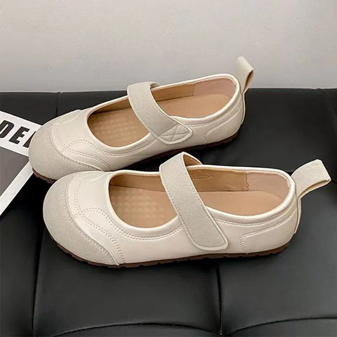 2025 New Women's Mary Jane Flats - Adjustable Strap Slip-On in beige color on a stylish black surface.
