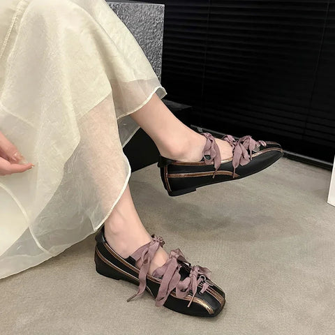 Mary Jane Ballet Flats showing round toe low heel design with lace-up in black and purple, styled with a flowy skirt.